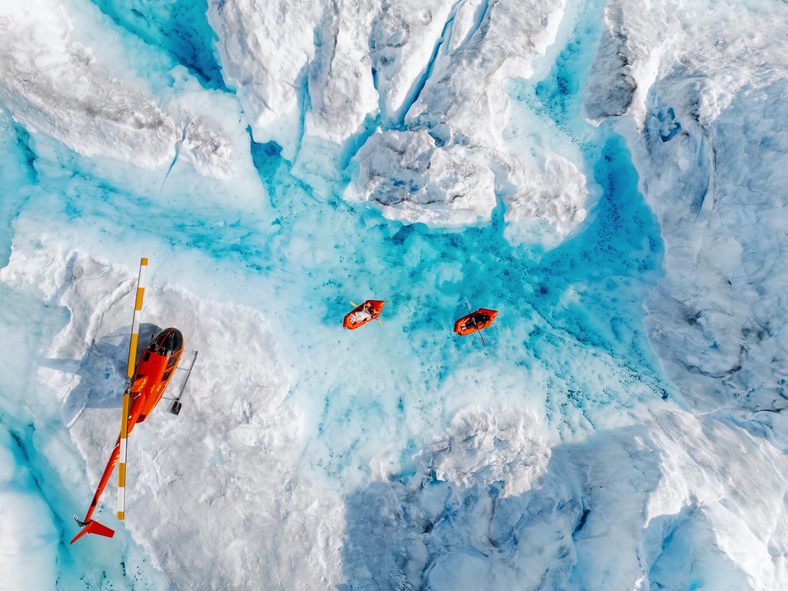 Alaska Helicopter Elopement Couple kayaking in a glacier pool