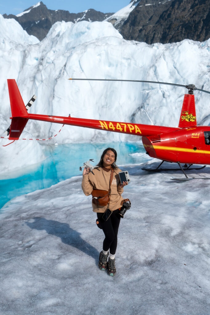 Alaska Elopement Photographer next to a helicopter on a glacier