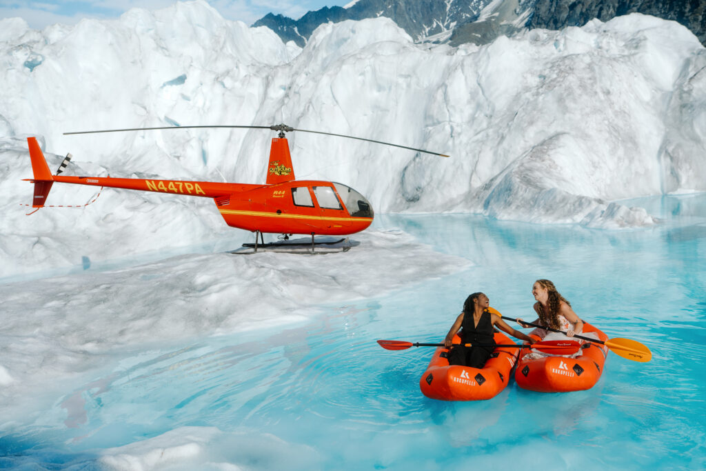 Alaska Helicopter Elopement Couple kayaking in a glacier pool