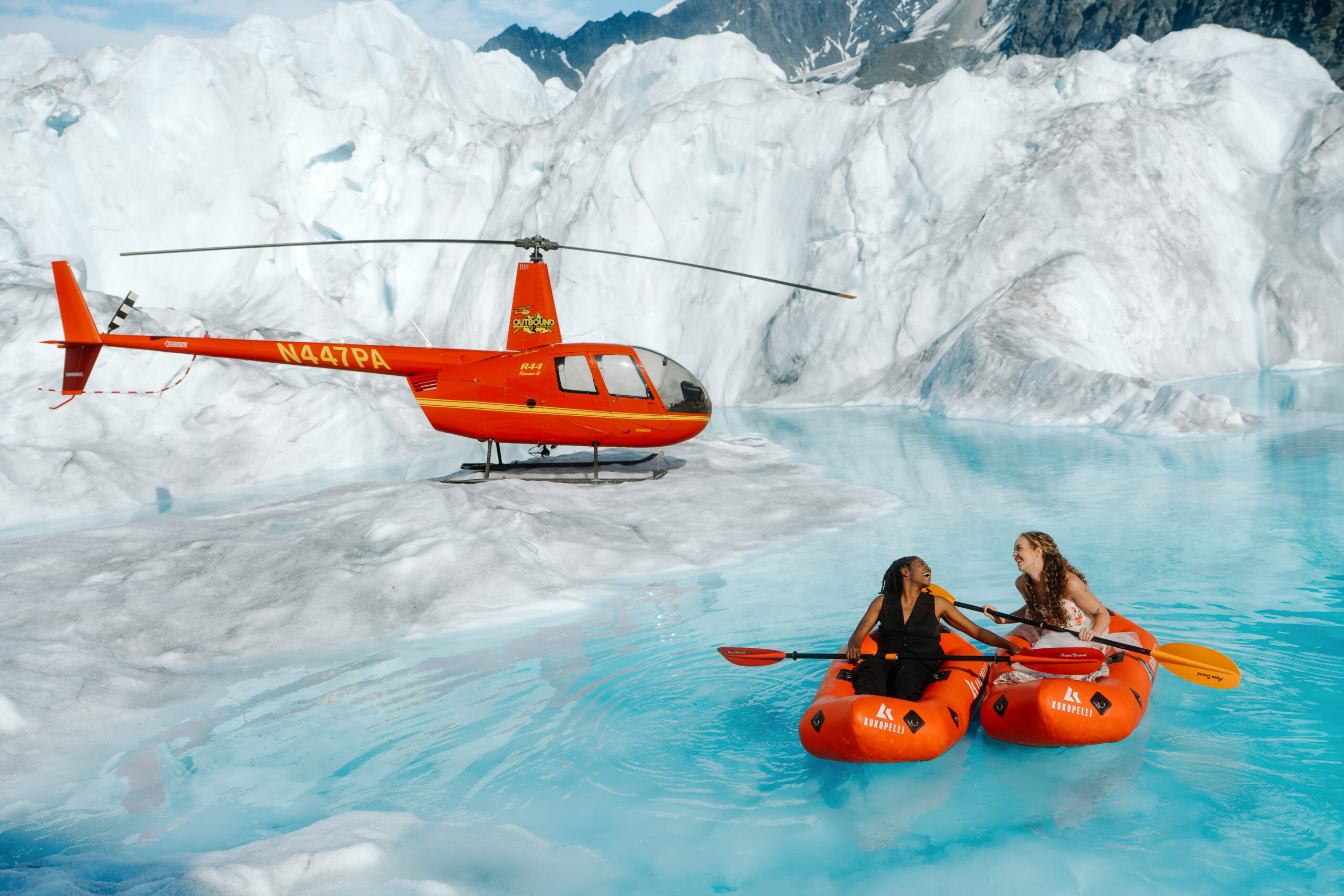 Alaska Helicopter Elopement Couple kayaking in a glacier pool