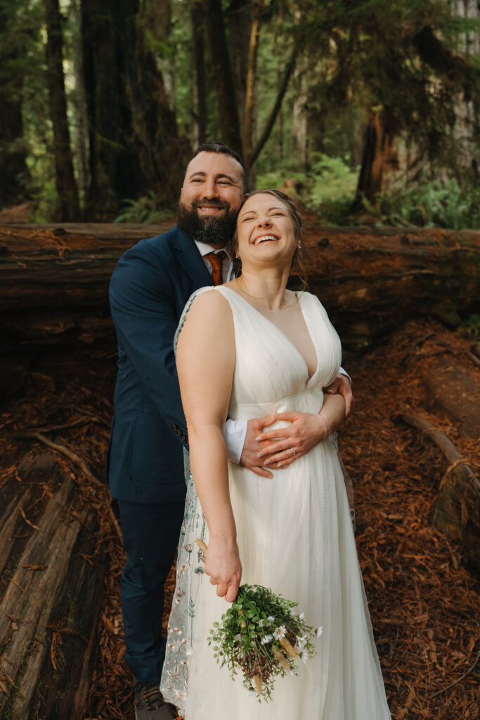 Couple laughing in the Redwoods after Elopement